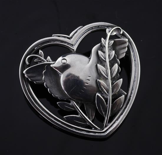 A Georg Jensen sterling silver brooch by Arno Malinowski, no 329, modelled as a bird in a pierced foliate and heart surround